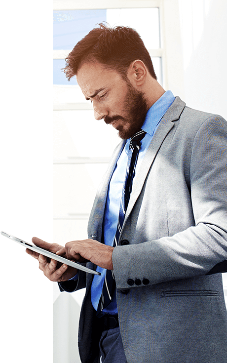 A man stands while making use of a tablet device running Mobile 1’s Enterprise Mobility solution